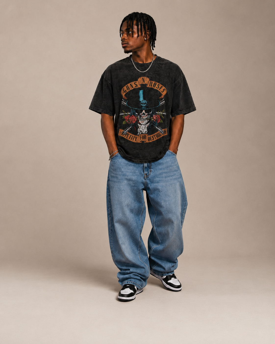 Model wearing a graphic tee with relaxed denim and trainers